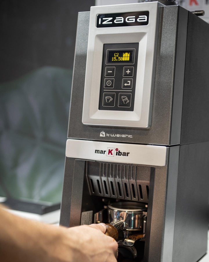 Markibar IZAGA W grinder dosing into a portafilter on a café bar